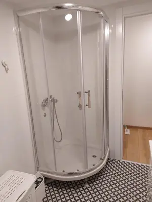 a shower with a glass enclosure in a bathroom at Apartment S in Belgrade