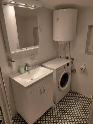 a bathroom with a washing machine and a sink at Apartment S in Belgrade