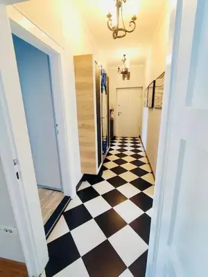 a hallway with a black and white checkered floor at Vracar hideaway with private garage in Belgrade