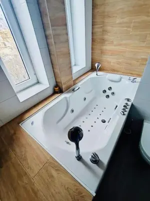 a bath tub in a bathroom with a window at Vracar hideaway with private garage in Belgrade