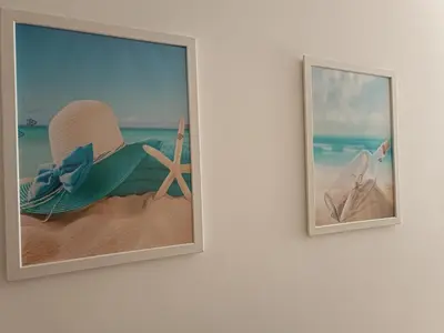 two pictures of a beach with a hat and a starfish at Stella Apartment in Karaburma