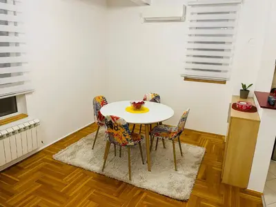 a dining room with a table and chairs at Jolly Apartment - Belgrade in Belgrade