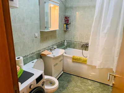 a bathroom with a toilet and a tub and a sink at Jolly Apartment - Belgrade in Belgrade