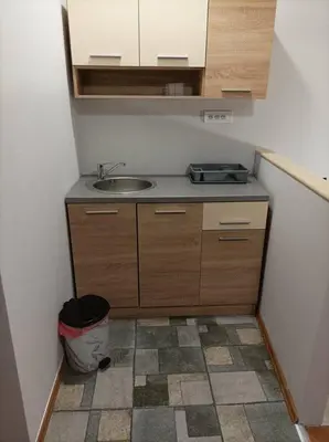 a small kitchen with a sink and a trash can at Katera in Belgrade