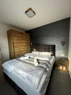 a bedroom with a large bed with white sheets and pillows at Ortak Apartments in Belgrade