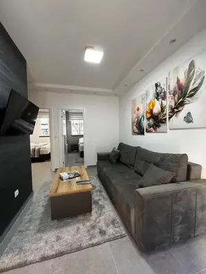 a living room with a couch and a table at Ortak Apartments in Belgrade