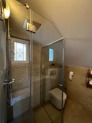 a bathroom with a shower and a toilet at Ortak Apartments in Belgrade