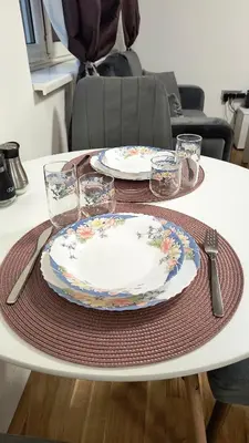 a table with two plates and glasses on it at TALIJA in Vračar (historical)