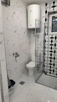 a white bathroom with a shower and a toilet at TALIJA in Vračar (historical)