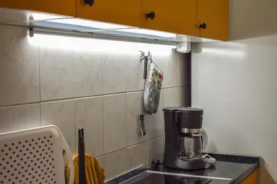 a kitchen sink with a coffee maker on a counter at Lana's home in the best part of the city in Vračar (historical)