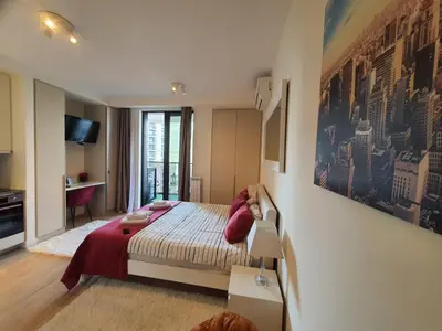 a bedroom with a bed with red pillows on it at Belgrade Waterfront Apartment - Beograd na vodi in Belgrade