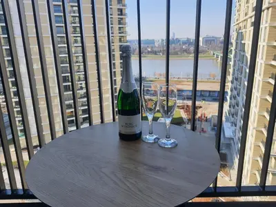 a bottle of wine and two glasses on a table at Belgrade Waterfront Apartment - Beograd na vodi in Belgrade