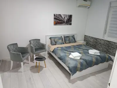 a bedroom with a bed and a desk and a chair at Savska - Apartment in Sajmište