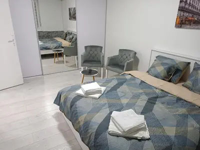 a bedroom with a bed with towels on it at Savska - Apartment in Sajmište