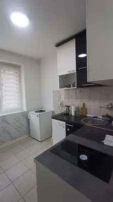 a kitchen with a sink and a counter top at Savska - Apartment in Sajmište