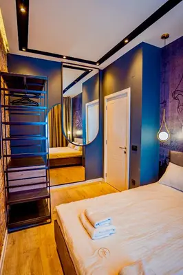 a bedroom with a large bed with a blue wall at Miha Premium Apartment in Belgrade