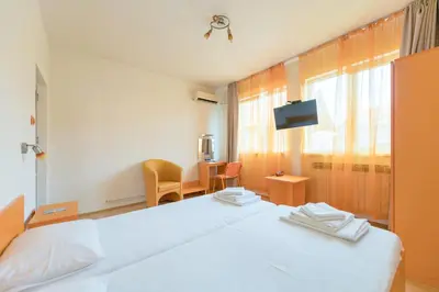 a hotel room with a bed and a tv at Hotel Villa Sarto in Belgrade