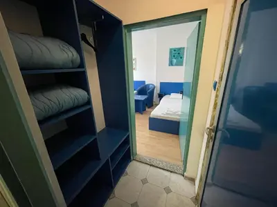 a room with a door open to a room with a bedroom at Hotel Villa Sarto in Belgrade