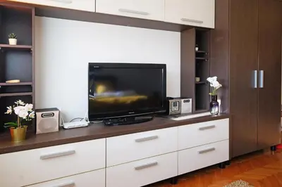 a living room with a tv on a white dresser at Apartment Paradise Serenity in Belgrade