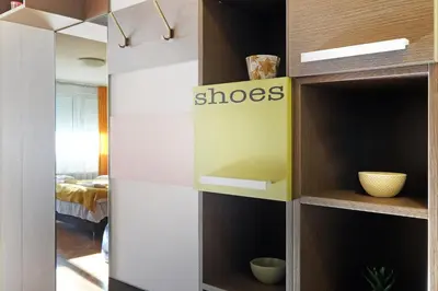 a walk in closet with wood and white shelves at Apartment Paradise Serenity in Belgrade