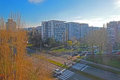 a city with tall buildings and a parking lot with cars at Apartment Paradise Serenity in Belgrade
