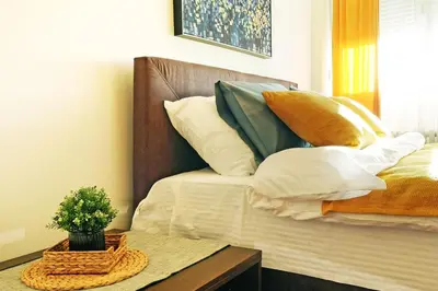 a bed with a bunch of pillows on it at Apartment Paradise Serenity in Belgrade