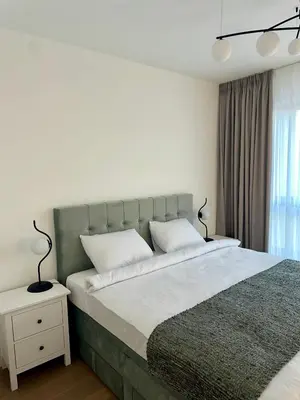 a bedroom with a large bed and a window at Skyway Apartment Belgrade Waterfront in Belgrade