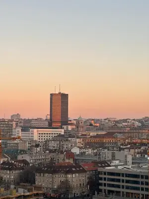 a view of a city skyline at sunset at Skyway Apartment Belgrade Waterfront in Belgrade
