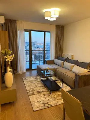 a living room with a couch and a table at Skyway Apartment Belgrade Waterfront in Belgrade