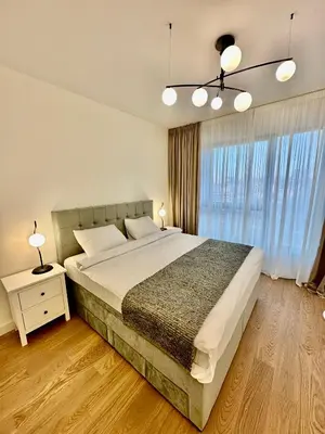 a bedroom with a large bed and a window at Skyway Apartment Belgrade Waterfront in Belgrade