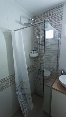 a bathroom with a shower and a sink at Trgovacka Zarkovo - Apartman in Žarkovo