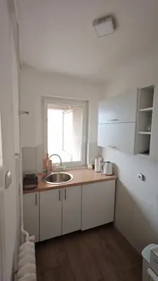 a small kitchen with a sink and a window at Trgovacka Zarkovo - Apartman in Žarkovo