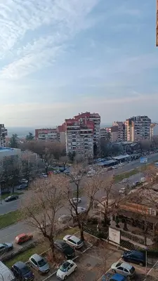 a city with cars parked in a parking lot at Trgovacka Zarkovo - Apartman in Žarkovo