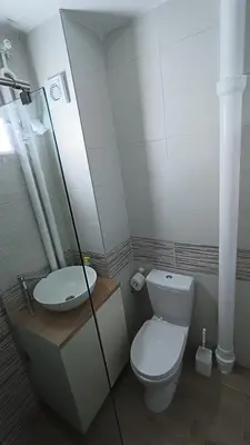 a bathroom with a toilet and a sink at Trgovacka Zarkovo - Apartman in Žarkovo