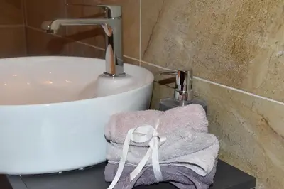 a bathroom with a sink and a towel at Tiffany Belgrade apartment in Belgrade