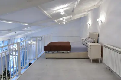 a bedroom with a bed and a balcony at Tiffany Belgrade apartment in Belgrade