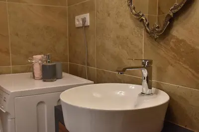 a bathroom with a white sink and a mirror at Tiffany Belgrade apartment in Belgrade