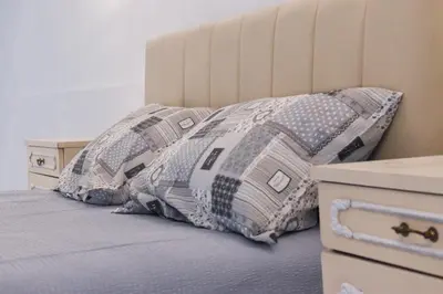 a bed with two pillows on top of it at Tiffany Belgrade apartment in Belgrade