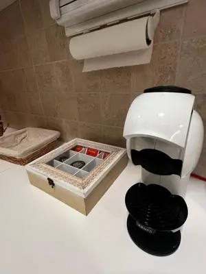 a coffee maker sitting on a counter next to a box at Real Apartment Banovci in Novi Banovci
