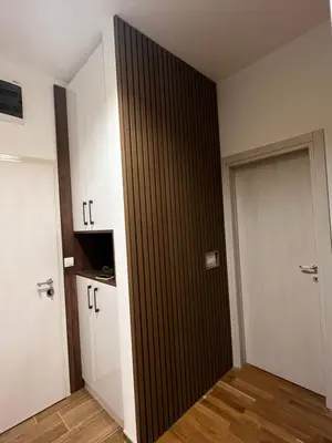 a room with a black door and a white cabinet at Real Apartment Banovci in Novi Banovci