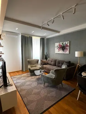 a living room with a couch and two chairs at Real Apartment Banovci in Novi Banovci