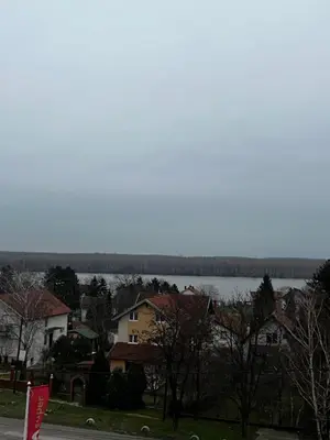 a view of a town with a lake and houses at Real Apartment Banovci in Novi Banovci
