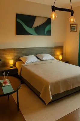 a bedroom with a large bed and a table at Little L Apartment Obilic in Belgrade