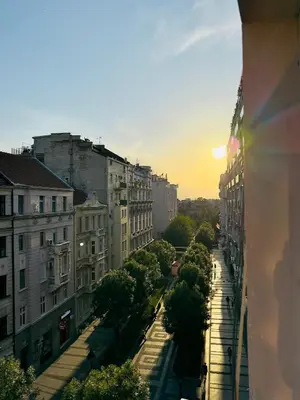 a view of a city street at sunset at Little L Apartment Obilic in Belgrade