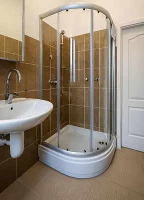 a bathroom with a shower and a sink at Little L Apartment Obilic in Belgrade