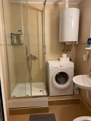 a bathroom with a shower and a washing machine at 3-rooms Arena apartment in Belgrade