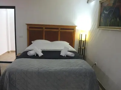 a bedroom with a large bed with two pillows at Rooms&Restaurant 43 in Belgrade