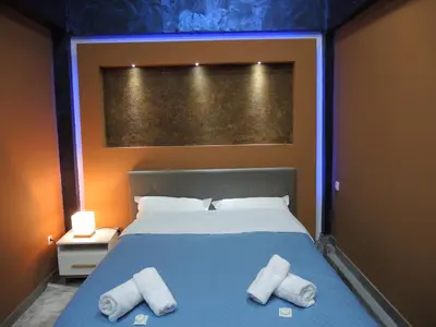a bedroom with a bed with two towels on it at Rooms&Restaurant 43 in Belgrade