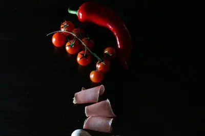 a pile of chocolate and cherries and a red pepper at Rooms&Restaurant 43 in Belgrade