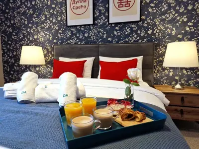 a tray with drinks and food on a bed at Family & Friends Apt, Skadarlija in Belgrade